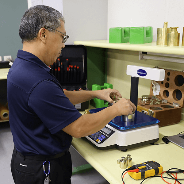 Wedderburn service and maintenance staff repairing scale